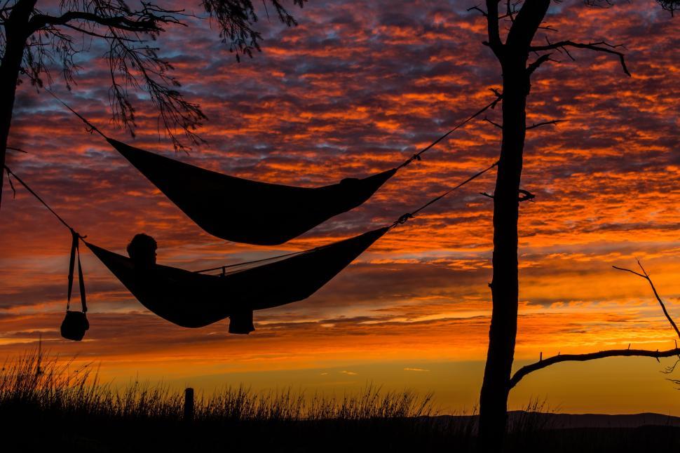 A person relaxing on a hammock